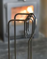 Close Up Of "The Turville" Three Piece Companion Set Handles In A Fireside Setting