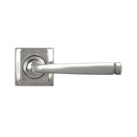 The Valen Tapered Sprung Handle Set on a Square Rose in Satin Stainless Steel Shown from the Front on a White Background