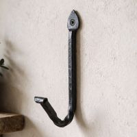 The Vertical Wrought Iron Spearhead Coat Hook Shown Close up on a Cream Coloured Wall - Digital Illustration