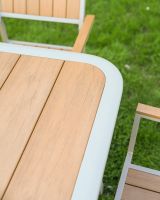 The Verve Quadrat 4 in Seater Outdoor Dining Set in Champagne Showing a Close up of One of the Rounded Corners of the Table