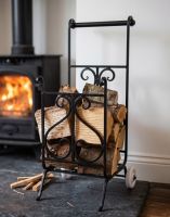 The Viking Wrought iron Log Trolley with Split Logs next to a Log Burner Stove - Digital Illustration 