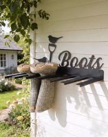 The Wall Mounted Robin Iron Boot Holder Fixed to a Wooden Panel Exterior Garden Wall - Digital Illustration The Wall Mounted Robin Iron Boot Holder Fixed to a Wooden Panel Exterior Garden Wall - Digital Illustration