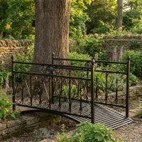 The Westminster Victorian Ornate Wrought Iron Garden Bridge in a Black Finish Showing the Full Bridge over a Small Stream - Digital Illustration The Westminster Victorian Ornate Wrought Iron Garden Bridge in a Black Finish Showing the Full Bridge over a Small Stream - Digital Illustration
