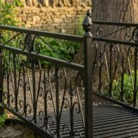 The Westminster Victorian Ornate Wrought Iron Garden Bridge in a Black Finish Shown at an Angle with the Walkway - Digital Illustration The Westminster Victorian Ornate Wrought Iron Garden Bridge in a Black Finish Shown at an Angle with the Walkway - Digital Illustration