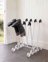 The White Catterick 4 Pair Boot and Welly Rack Mounted on a Stone Tiled Floor in a White Porch Entranceway - Digital Illustration