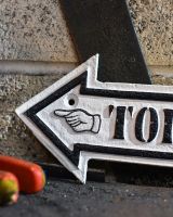 Close up of Toilets Arrow Vintage Style Cast Iron Sign Finish
