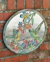 Angled view of colourful rustic finish garden wall mirror