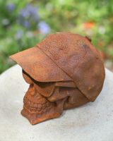 Close up of hat detail on rustic finish garden statue