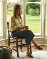 Person sat on Traditional Cross Hatch Tan Leather Wooden Chair