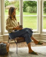 Traditional Hand Woven Tan Leather and Iron Arm Chair with Person Sat Down for Scale