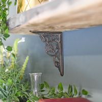Trellis Natural Iron Shelf Bracket in Use on a Blue Wall
