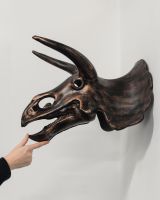 Triceratops Skull Cast Aluminium Wall Art with hand in shot for scale