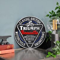 "Classic British Triumph Motorcycles" Cast Iron Vintage Wall Sign Next to a Blue Modern Wall "Classic British Triumph Motorcycles" Cast Iron Vintage Wall Sign Next to a Blue Modern Wall