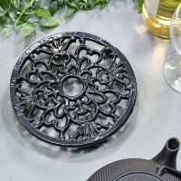 Heavy Duty Cast Iron Round Trivet Being Used on a Dining Room Table