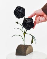 Twin bloom Upcycled Steel Botanical Sculpture in Wooden Base - Black with hand in shot
