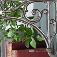 Detailed image of floral scrolls on shelf bracket