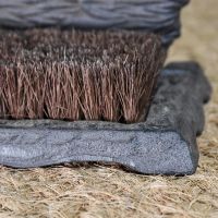 Close up of cast iron base, decorative detailing and brush Close up of cast iron base, decorative detailing and brush