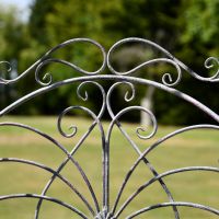 Close up of scroll detailing on antique grey arbour
