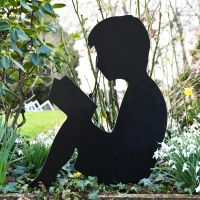 Metal Boy Reading Silhouette in situ in The Garden
