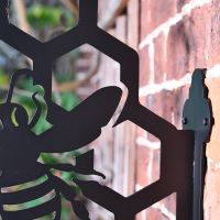 Close up of hexagonal pattern, bee and mounting bracket 