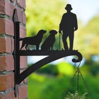 Man with Walking Stick and Two Labs Hanging Basket Bracket on Brickwork