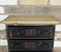 Close up of metal drawers & wooden table top Close up of metal drawers & wooden table top