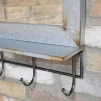 Close up of mirror with hooks 