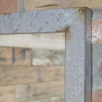 Close up of corner of mirror with rustic finish 