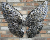 Antique Silver Angel Wings on Brick Wall 