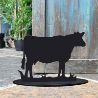 Cow Iron Door Stop Next to a Rustic Blue Door Cow Iron Door Stop Next to a Rustic Blue Door