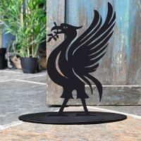 Liver Bird Iron Door Stop Next to a Rustic Blue Door Liver Bird Iron Door Stop Next to a Rustic Blue Door