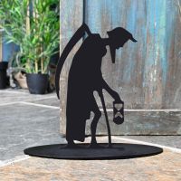 Old Father Time Iron Door Stop Next to a Rustic Blue Door Old Father Time Iron Door Stop Next to a Rustic Blue Door