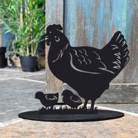 Hen & Chicks Iron Door Stop Next to a Rustic Blue Door