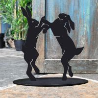 Boxing Hares Iron Door Stop Next to a Rustic Blue Door