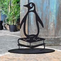 Penguin on Books Iron Door Stop Next to a Rustic Blue Door