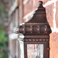 Side view of ornate detailing on half wall lantern