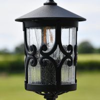 Close up of pillar light with central scroll design 