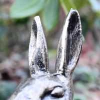 Close up of ears on sitting rabbit sculpture 