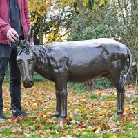 Donkey sculpture situated in garden 
