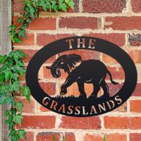 Elephant Iron Oval House Sign on a Brick Wall Elephant Iron Oval House Sign on a Brick Wall
