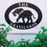 Elephant Iron Oval House Sign on a White Wall Elephant Iron Oval House Sign on a White Wall