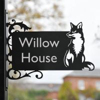 Sitting Fox Iron Bracket Name Sign in Front of a Home Sitting Fox Iron Bracket Name Sign in Front of a Home