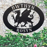 Welsh Dragon Iron Oval House Sign on a Stone Wall