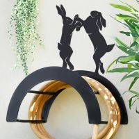 Wall Mounted Boxing Hares Iron Hose Holder Mounted to a Grey Garden Wall Wall Mounted Boxing Hares Iron Hose Holder Mounted to a Grey Garden Wall
