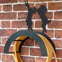 Wall Mounted Boxing Hares Iron Hose Holder Mounted to a Brick Wall Wall Mounted Boxing Hares Iron Hose Holder Mounted to a Brick Wall