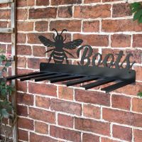 Wall Mounted Bumble Bee Iron Boot Holder Mounted on a Brick Wall Wall Mounted Bumble Bee Iron Boot Holder Mounted on a Brick Wall