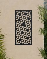 Black "Honeycomb Pattern Wall Art"s a beige wall surrounded by palm leaves