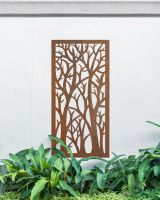 "Rustic Autumnal Trees Garden Wall Art" mounted onto a white garden wall amongst plants