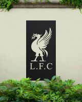 Black "Liver Bird Wall Art" on a cream garden wall surrounded by garden plants Black "Liver Bird Wall Art" on a cream garden wall surrounded by garden plants