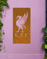 Rustic "Liver Bird Wall Art" mounted on a purple garden wall 